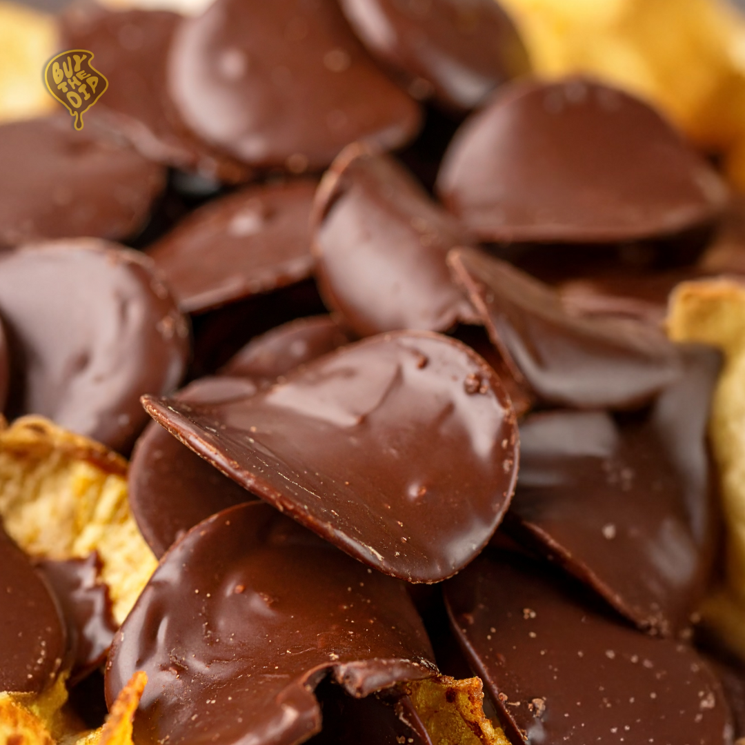 Close-up of belgian chocolate coated potato chips with glossy chocolate layer