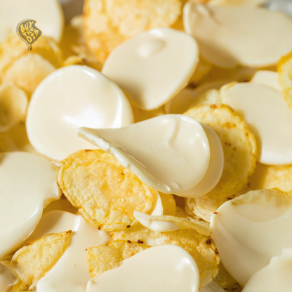 Close-up of white chocolate coated potato chips with glossy chocolate layer